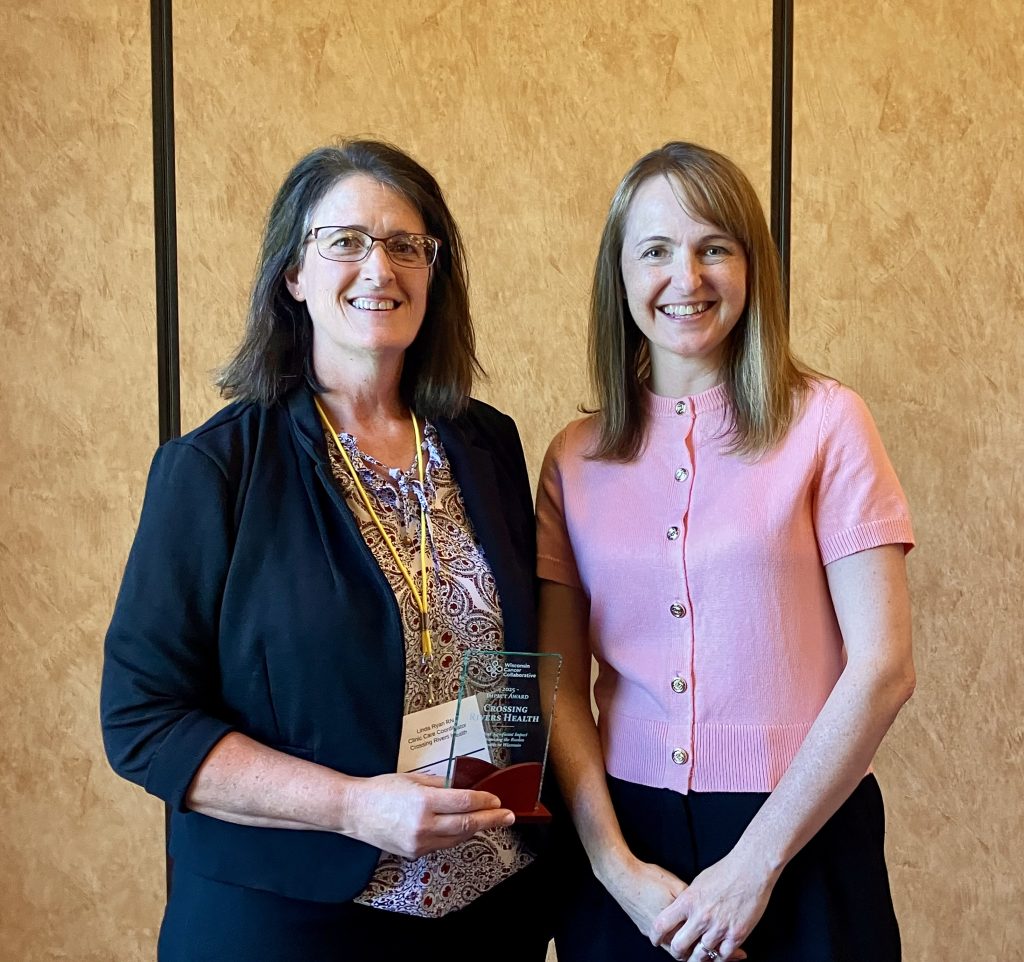 Linda Ryan, Clinic Care Coordinator at Crossing Rivers Health, accepting the 2025 Impact Award on behalf of Crossing Rivers
