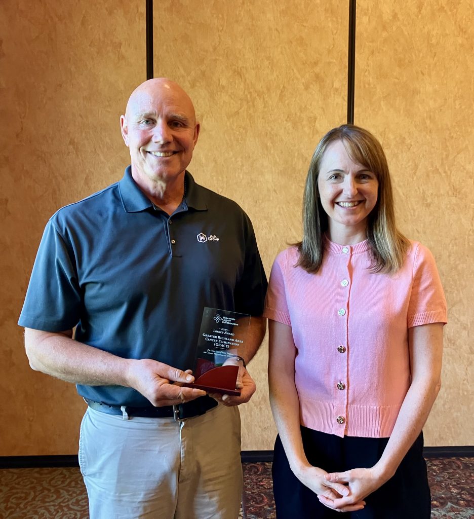 Leif Carlson, GRACE Board Member, accepting the 2025 Impact Award on behalf of Greater Richland Area Cancer Elimination (GRACE)